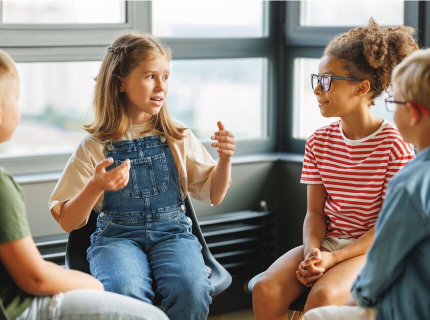 Elementary aged students engaged in group discussion.